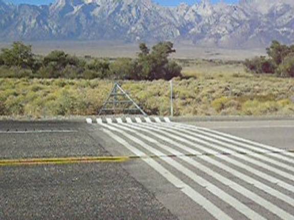 A 'virtual' cattle guard — white stripes painted across a highway near Lone Pine, California, imitating a real grid